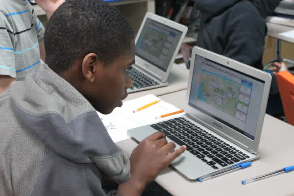 Students using laptops displaying the Citywide Dashboard