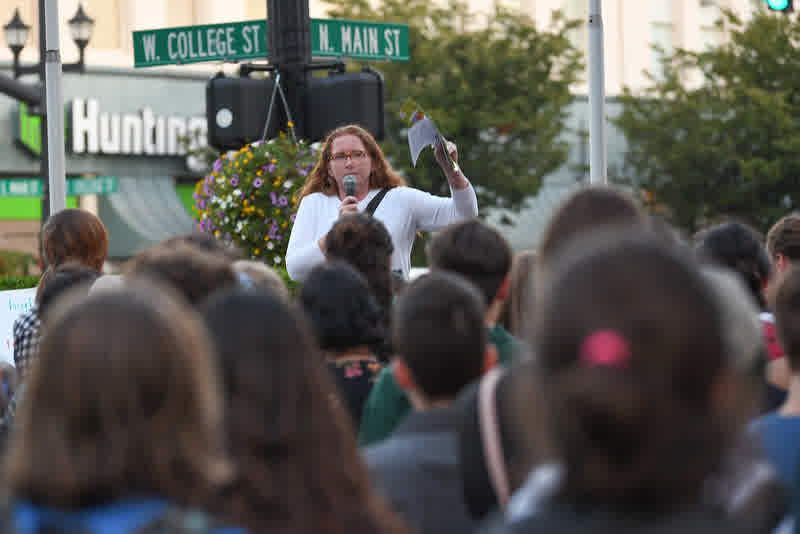 A speaker addressing a crowd at the corner of College and Main in Oberlin