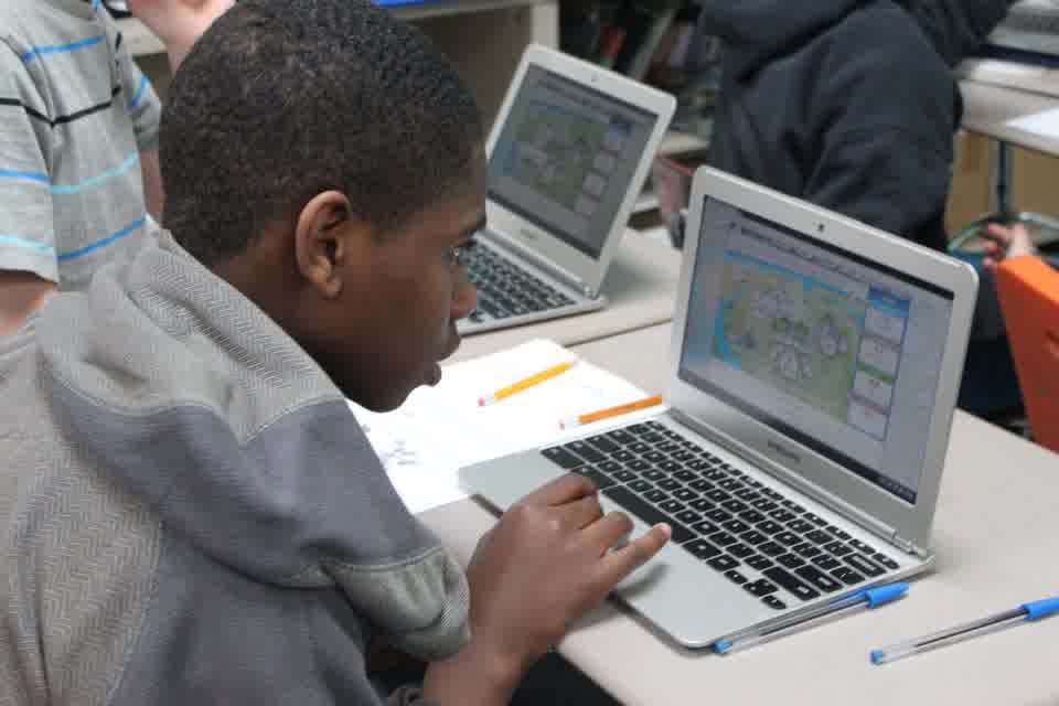 A student exploring resource-use information on a laptop